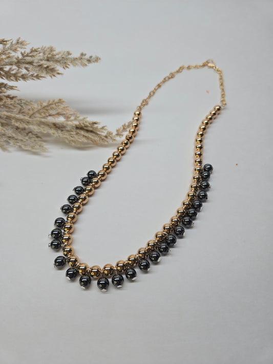 Golden Eclipse Necklace with hematite stones and gold-tone beads in a half-and-half design, view 2