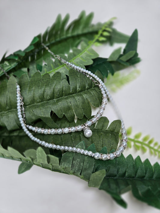 Moonlight Halo Necklace with two layers of white pearl-like beads and silver spacers, view 2