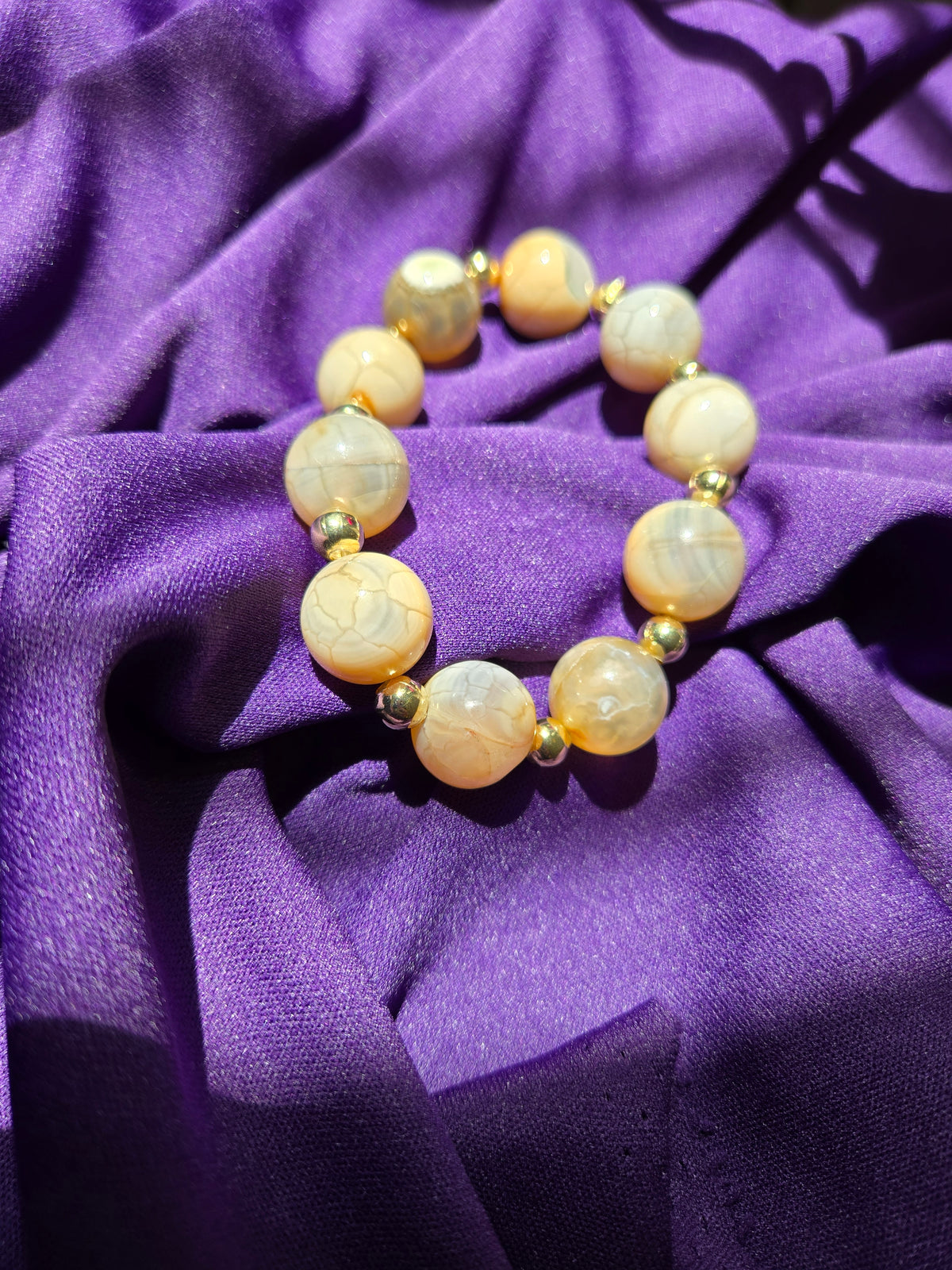 Golden Earth Bracelet with smooth, round natural stone beads in creamy tones, view 3