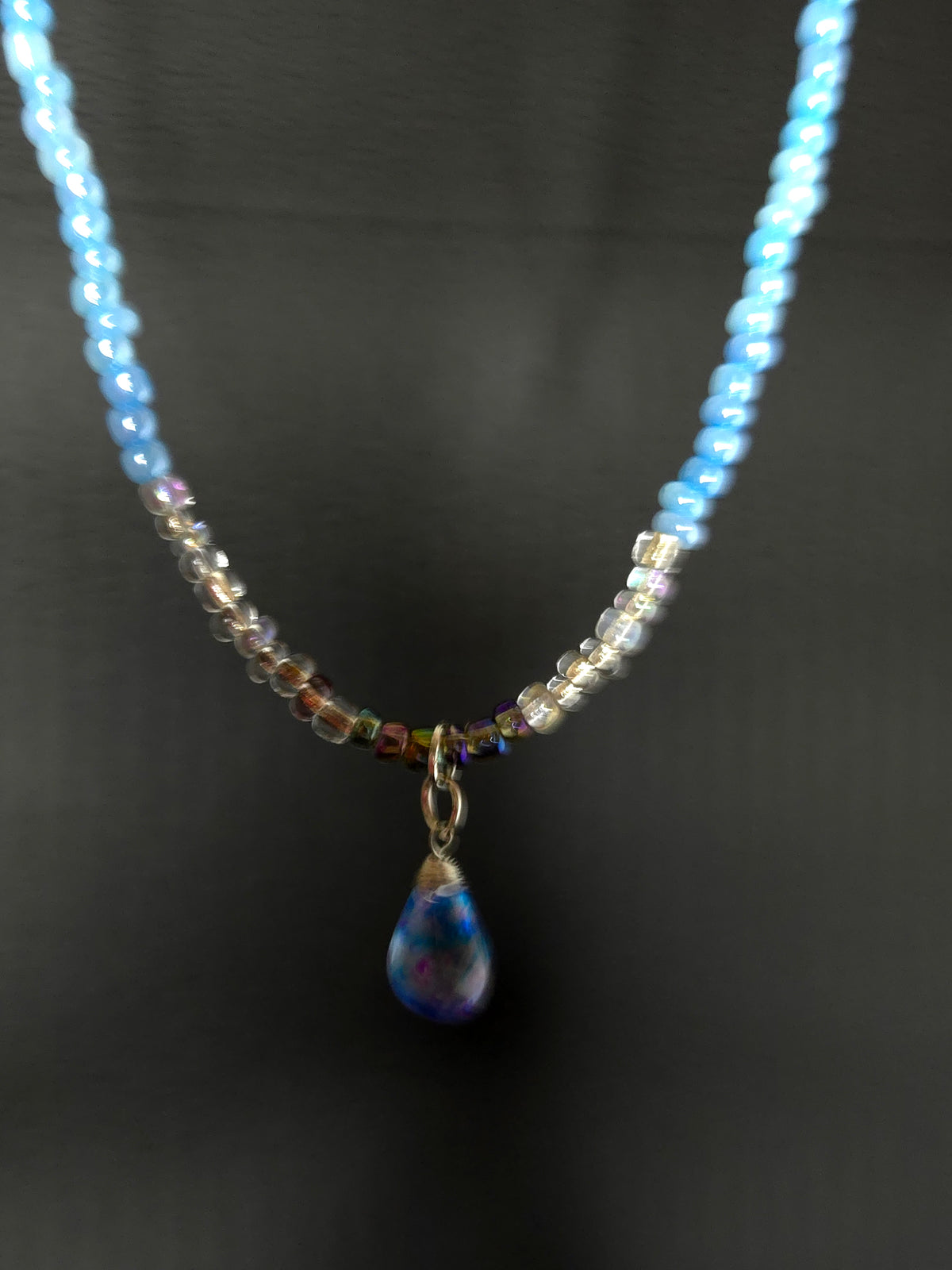 Blue Teardrop Necklace with clear-to-blue glass beads and a blue-violet teardrop pendant, view 3
