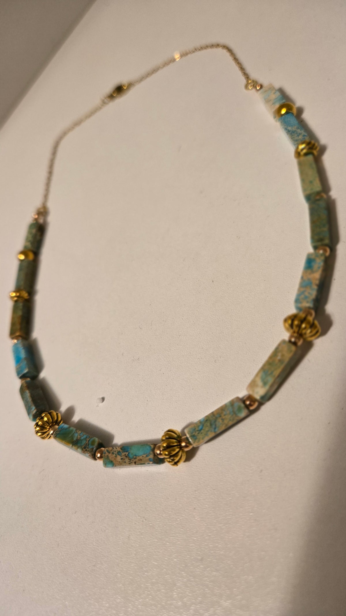 Ocean Whisper Necklace of turquoise-blue rectangular beads with gold-tone spacers, view 6