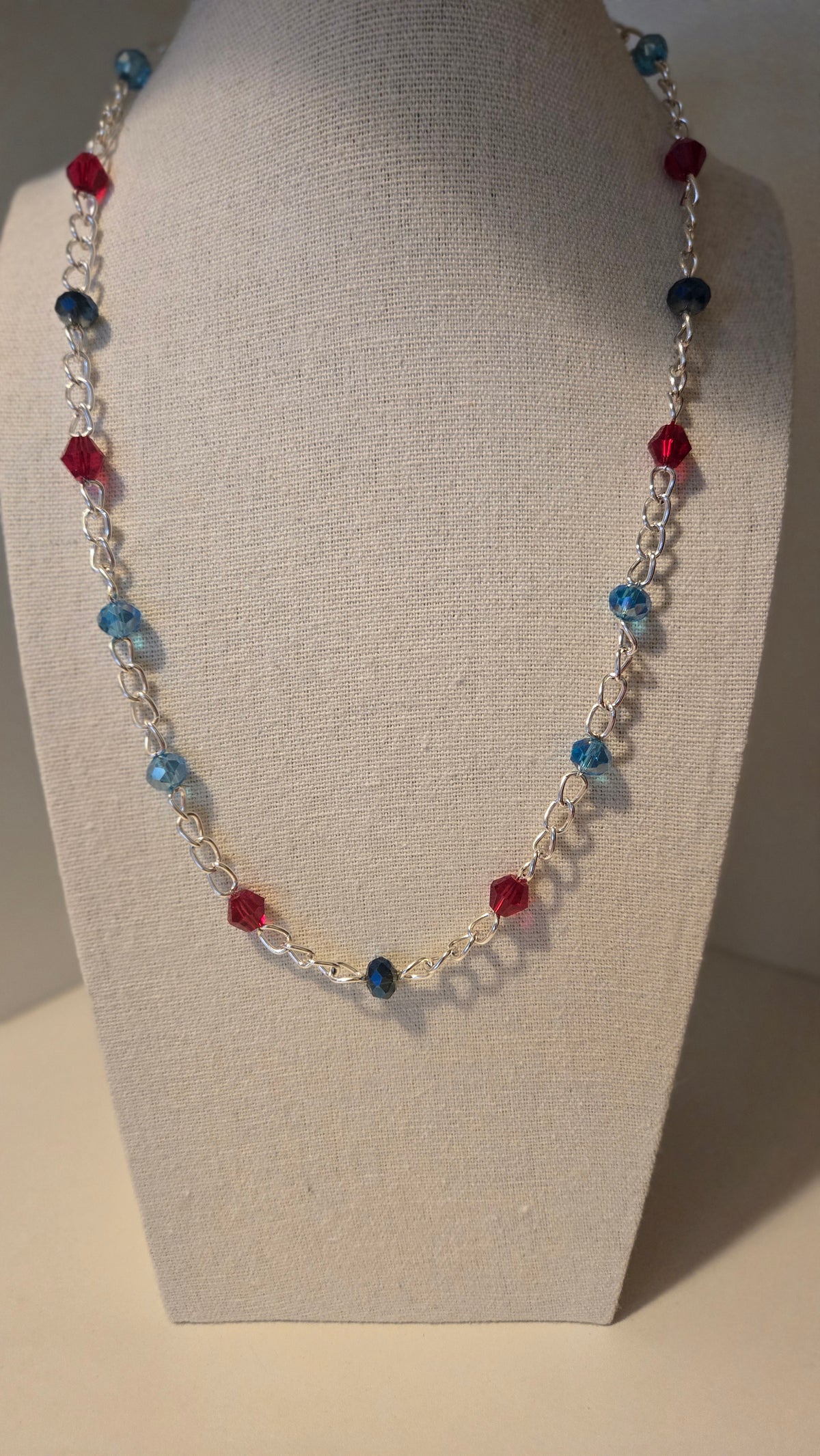 Dual Elegance Necklace with deep blue and red beads on a silver chain, view 3