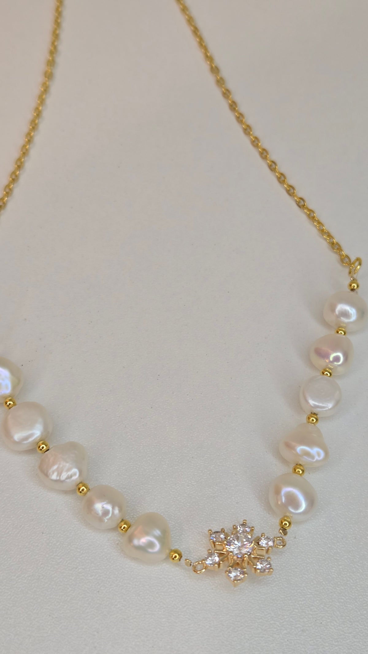 Pearl Blossom Gold-Tone Necklace with white bead accents and a floral centerpiece