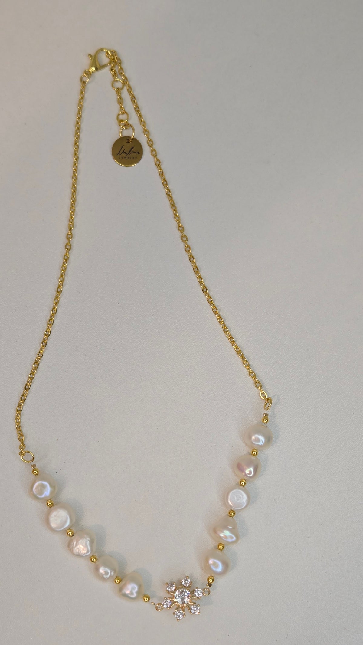 Pearl Blossom Gold-Tone Necklace with white bead accents and a floral centerpiece, view 3