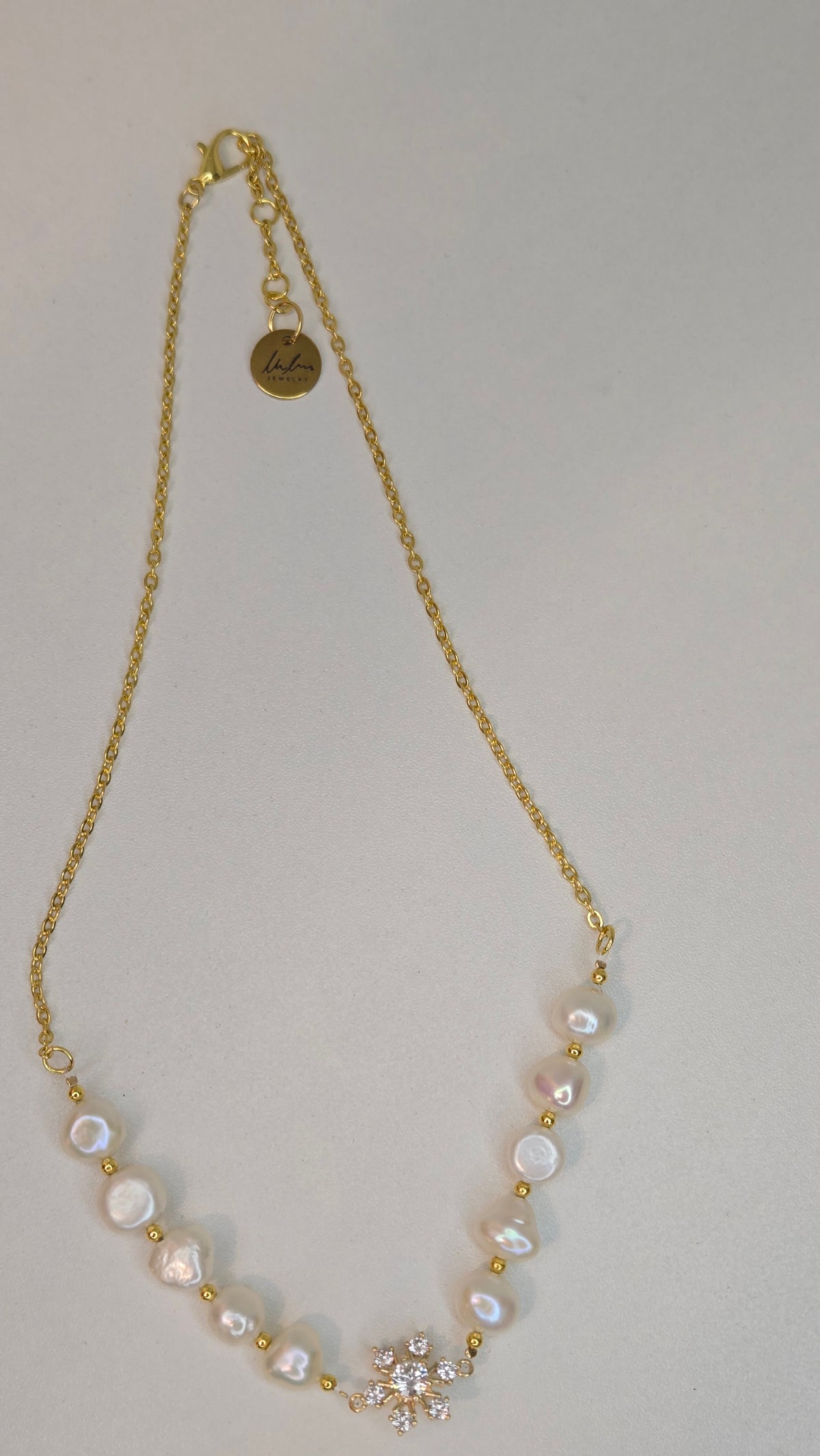 Pearl Blossom Gold-Tone Necklace with white bead accents and a floral centerpiece, view 4