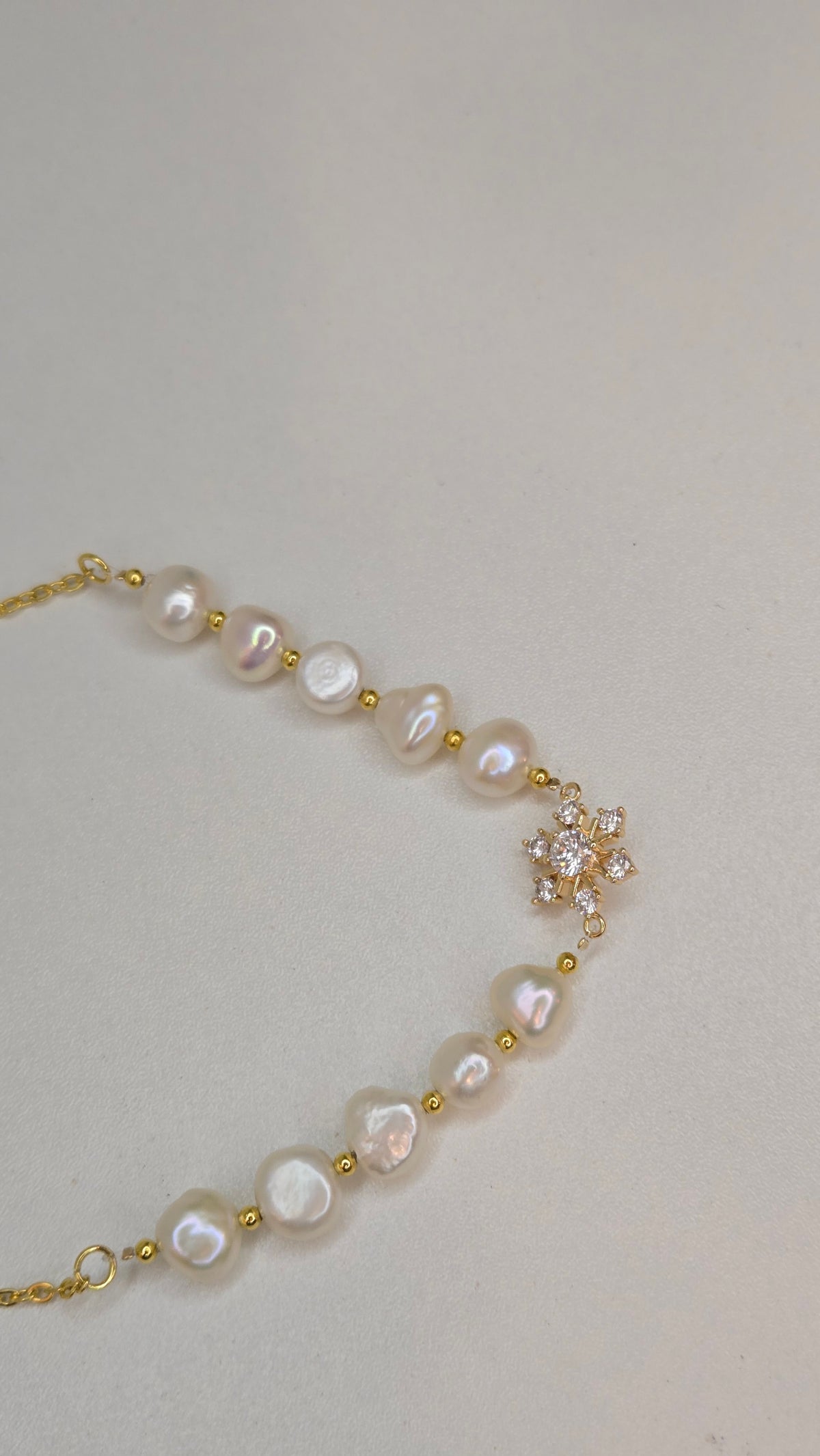 Pearl Blossom Gold-Tone Necklace with white bead accents and a floral centerpiece, view 5