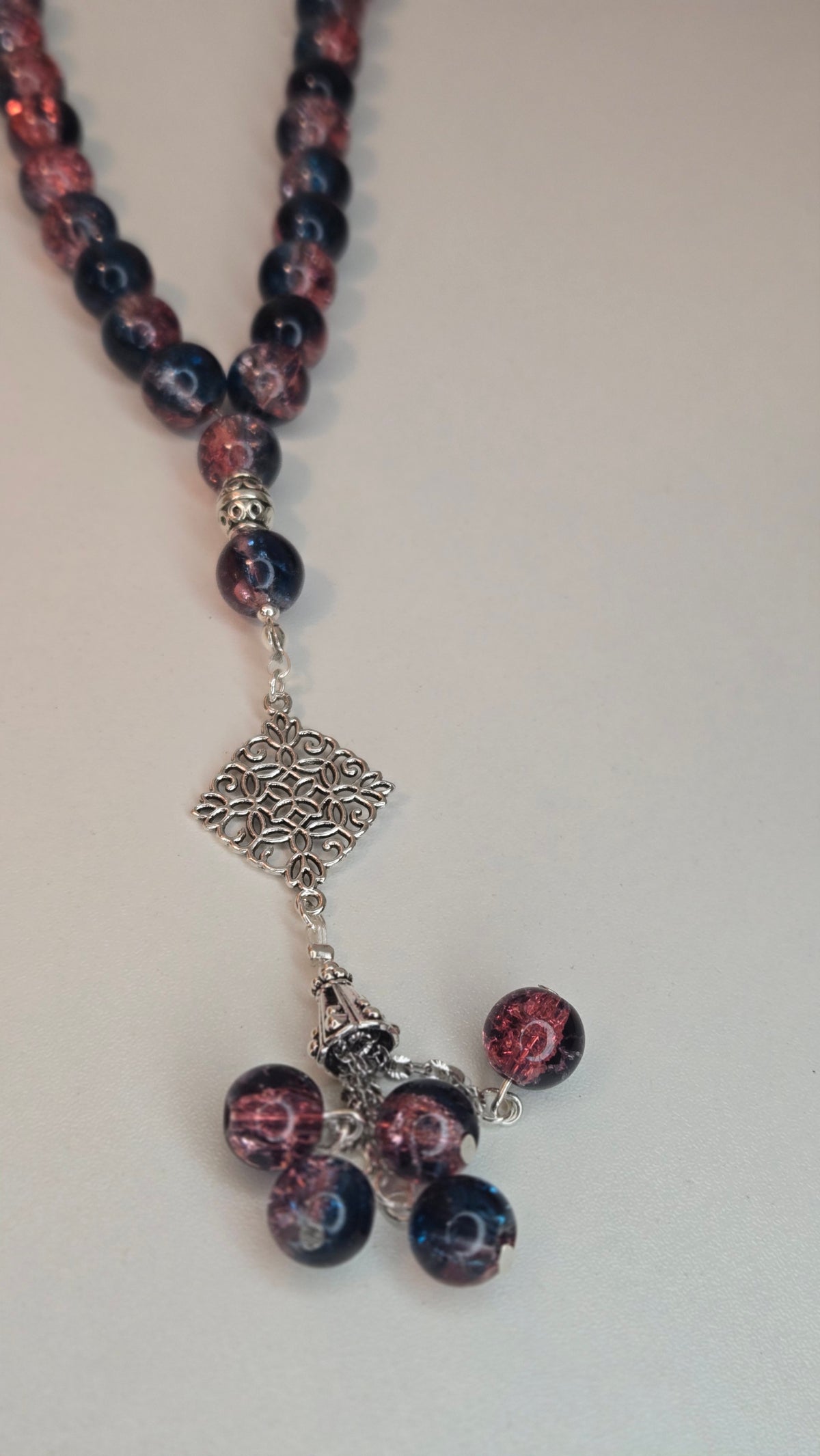 Midnight Bloom Prayer Beads with blue and rose marbled beads and an ornate charm, view 4