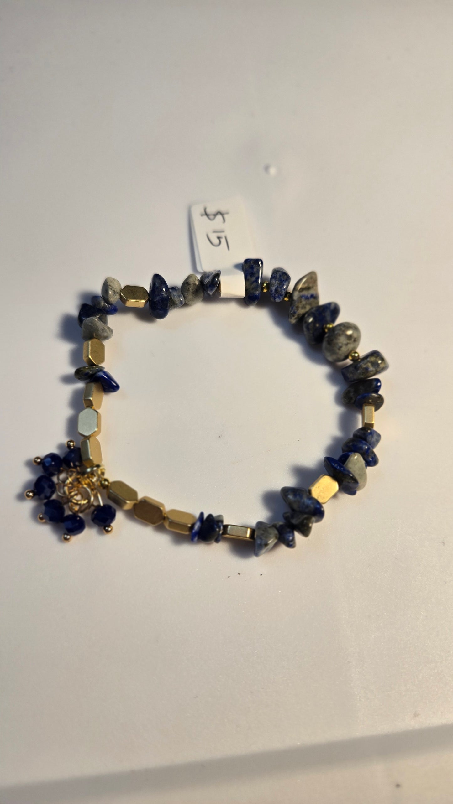Hand holding the unique Blue Serenity Handmade Bracelet, perfect as a thoughtful gift for women.