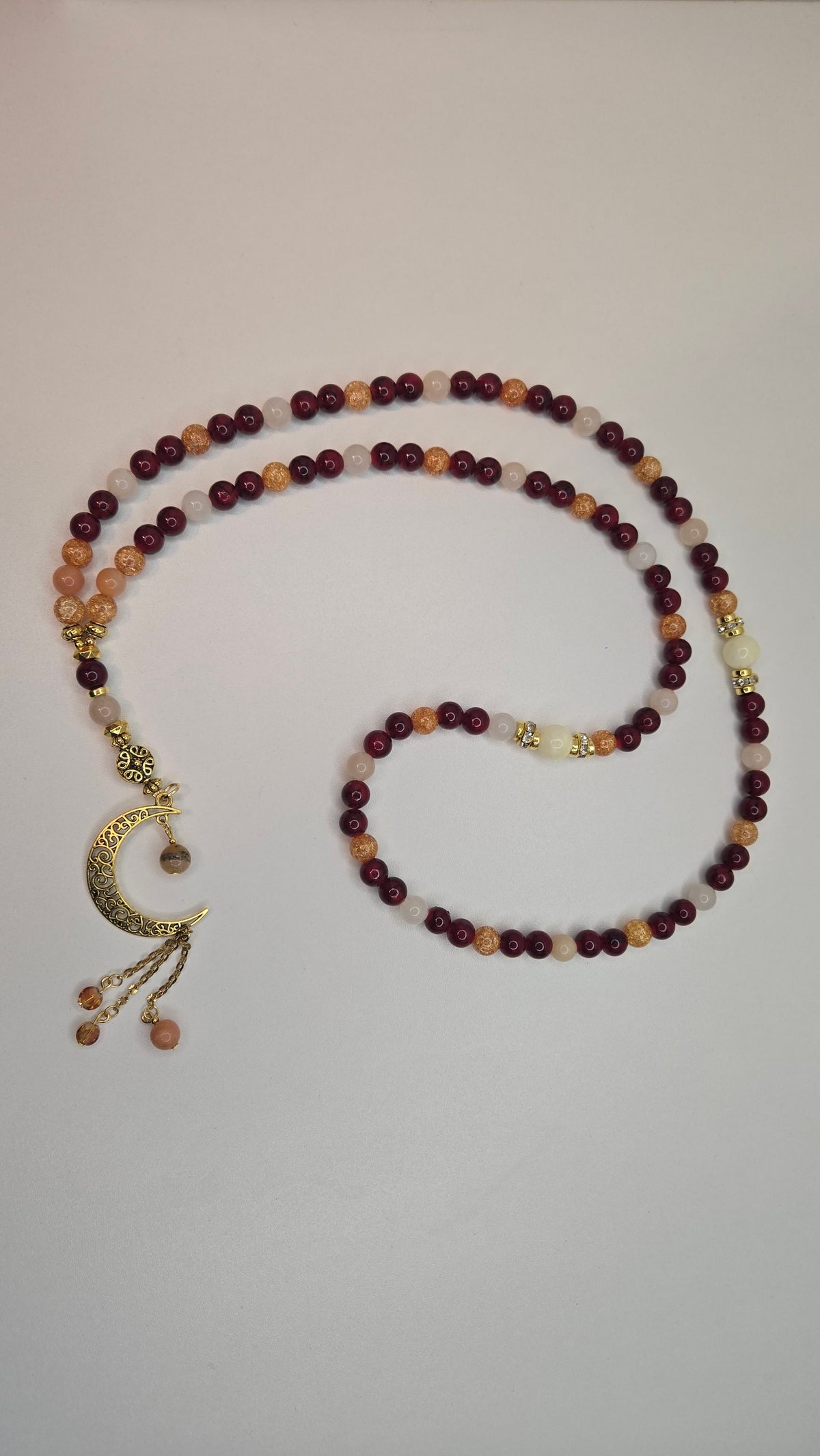 Golden Sunset Tasbih with red, orange and cream beads and a gold-tone crescent moon charm, view 3
