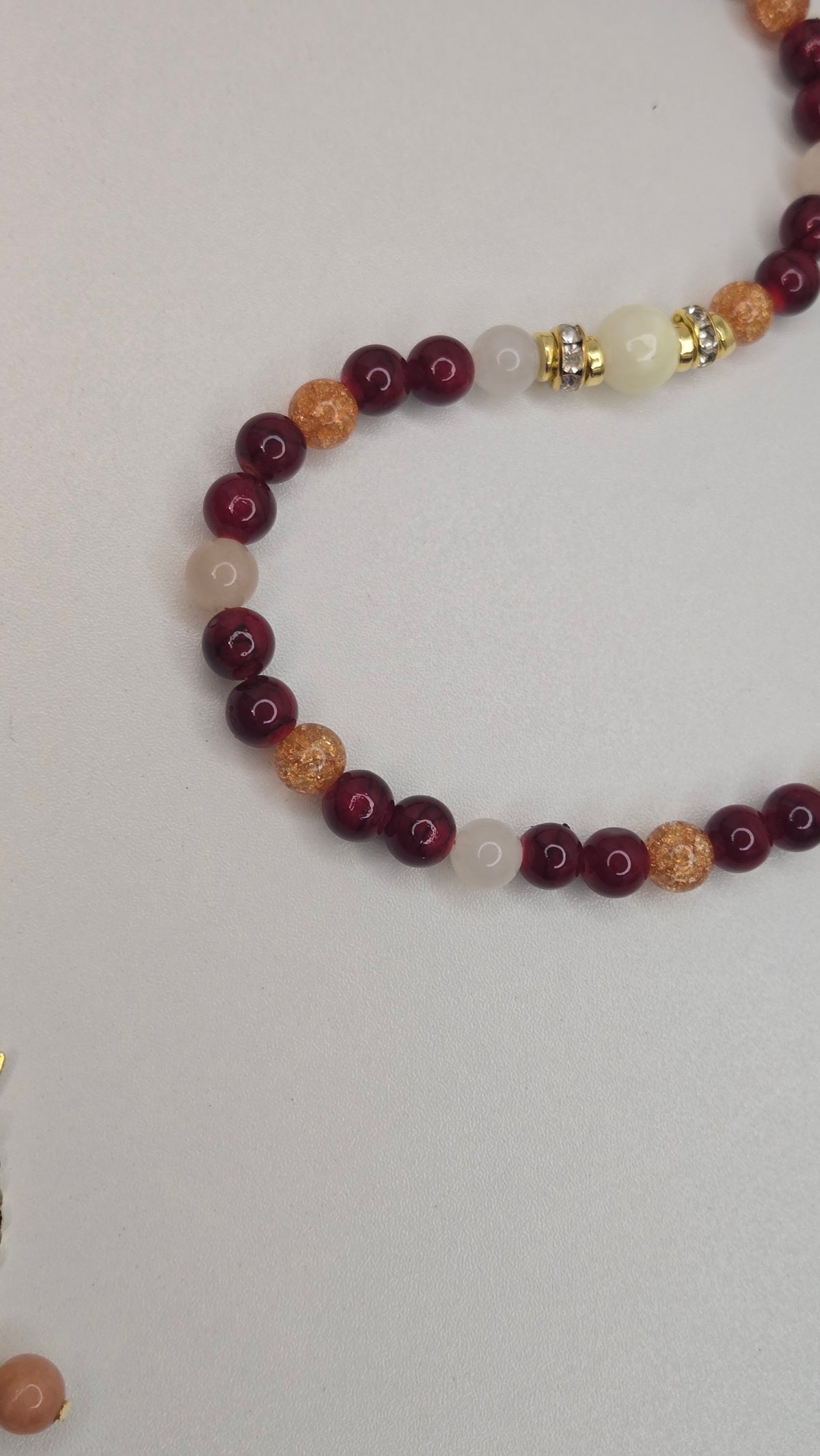 Golden Sunset Tasbih with red, orange and cream beads and a gold-tone crescent moon charm, view 4