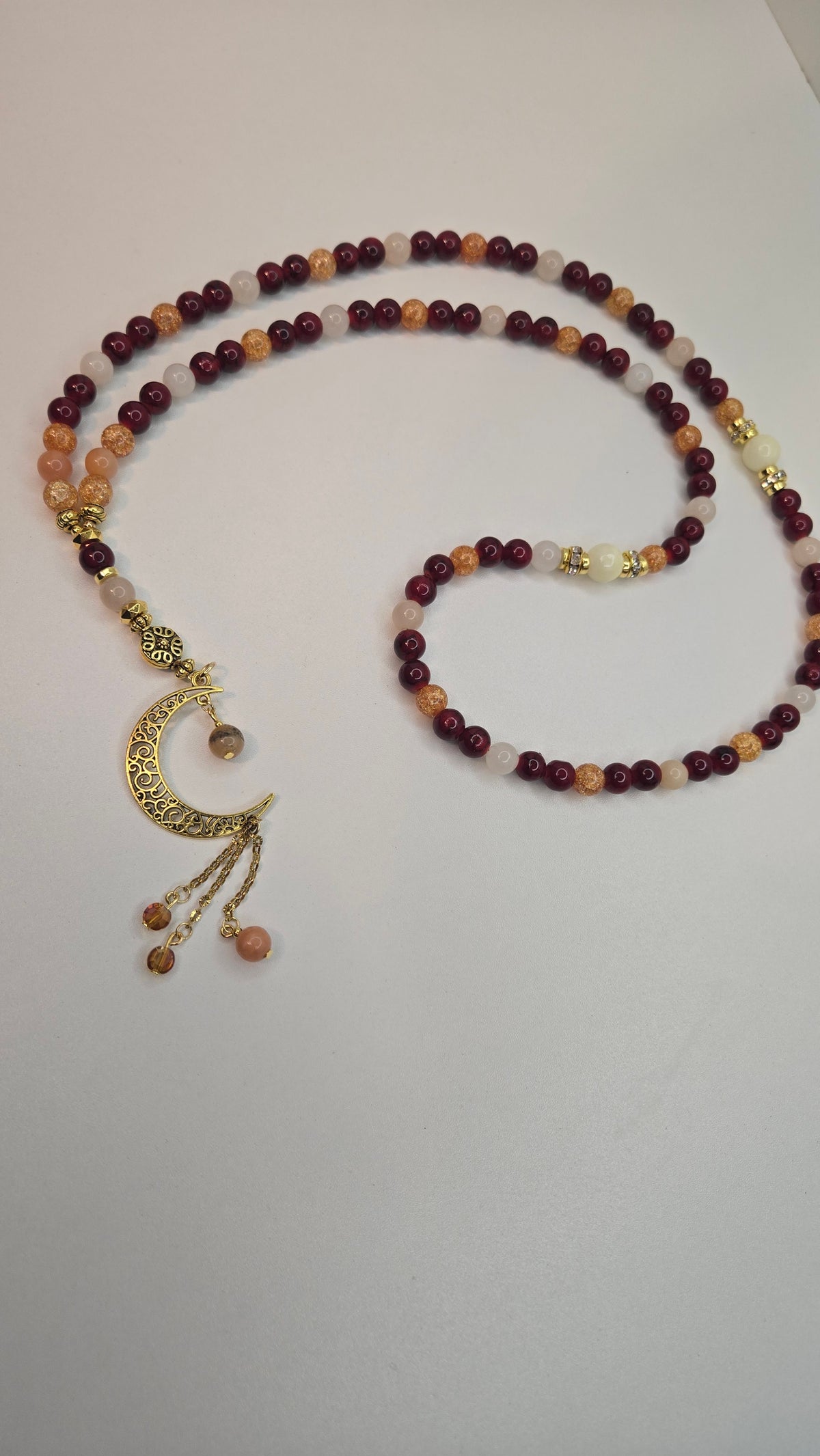 Golden Sunset Tasbih with red, orange and cream beads and a gold-tone crescent moon charm, view 5