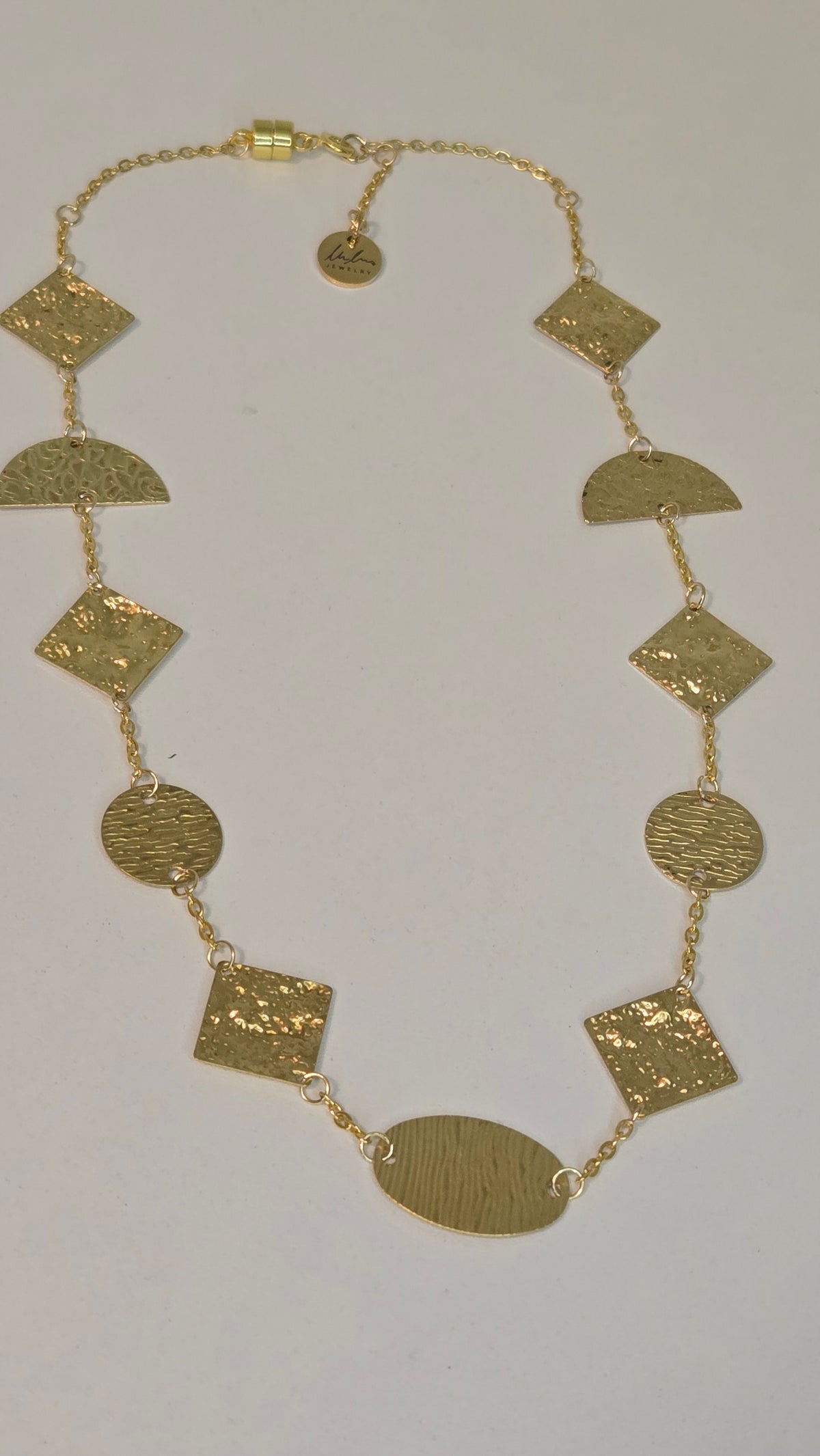 Golden Geometry Necklace with hammered gold-tone circles, half-circles and squares