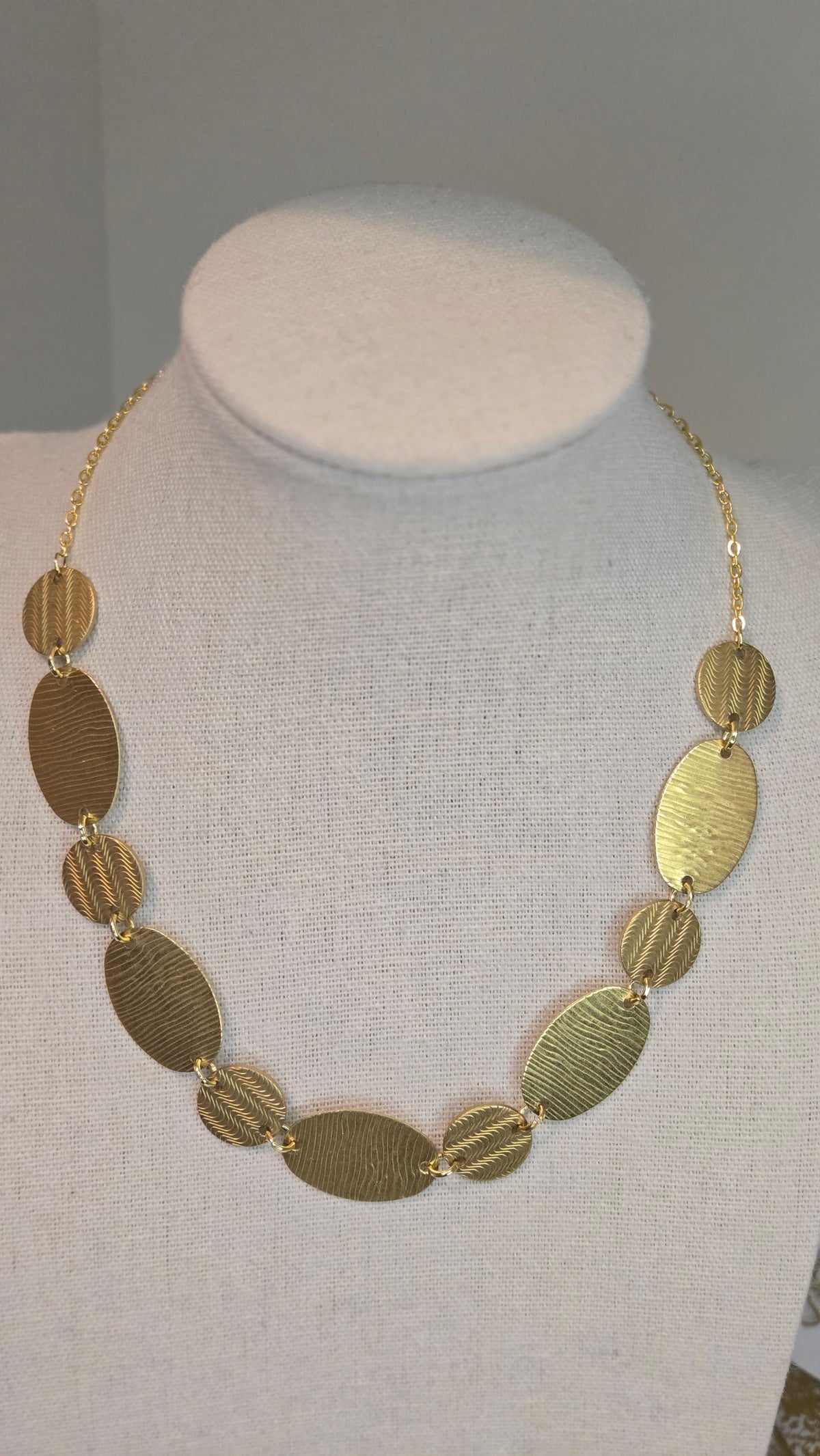 Golden Imprint Engraved Disc Necklace with an oval disc pendant on a gold-tone chain, view 3