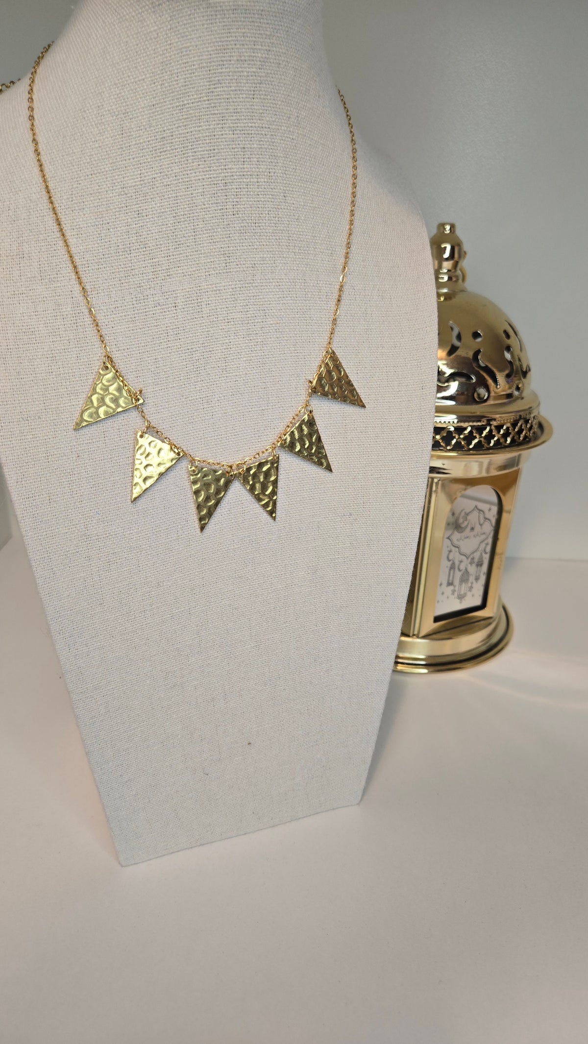 Golden Flames Necklace with hammered gold-plated triangle pendants on a chain, view 2