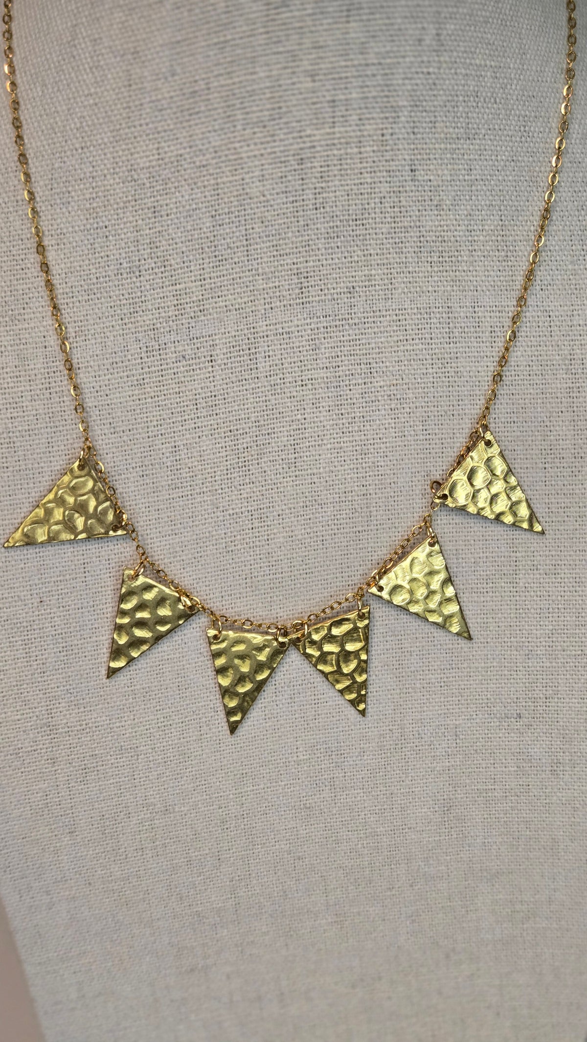 Golden Flames Necklace with hammered gold-plated triangle pendants on a chain, view 4