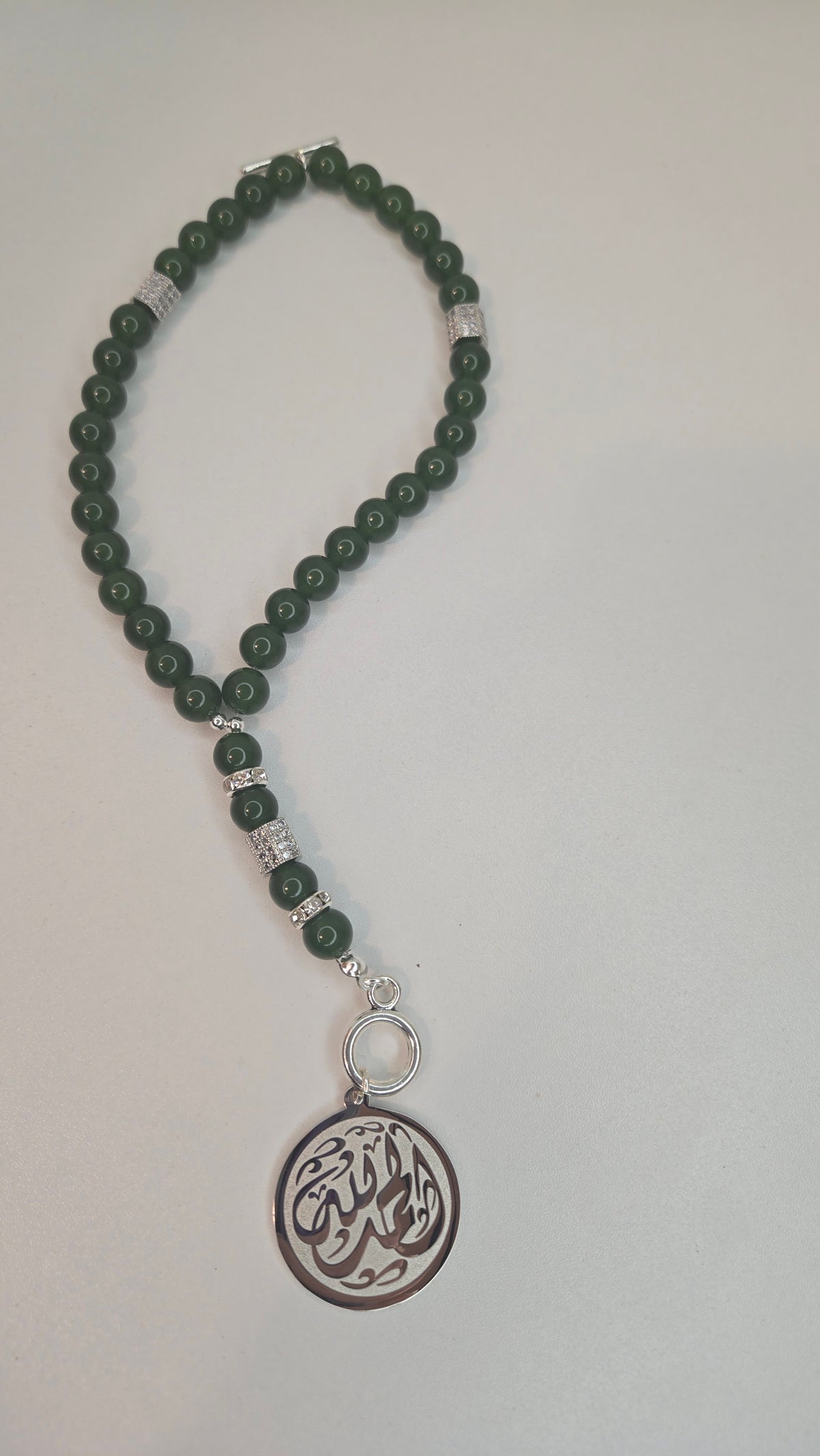 Royal Jade Tasbih with 8 mm green jade beads, silver accents and engraved medallion, view 2