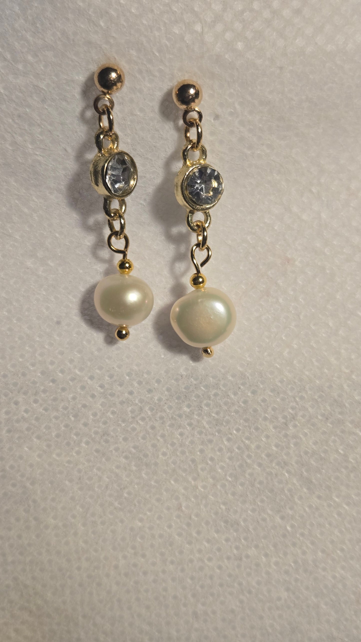 Close-up of Golden Pearl Grace Earrings showing intricate gold-tone design and clear round crystal