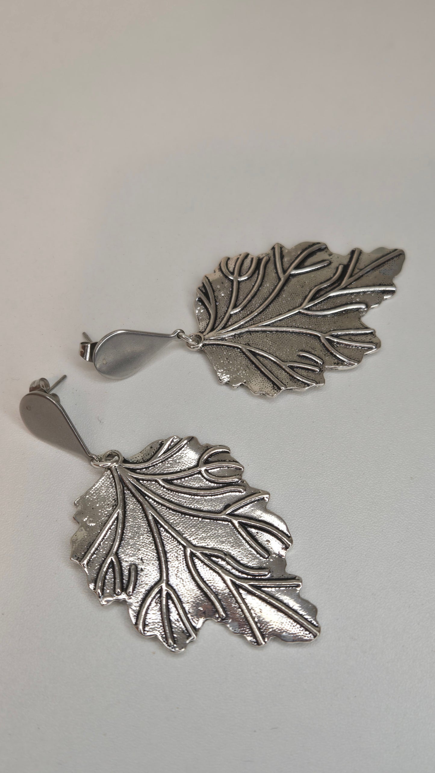 Model wearing silver leaf earrings, showcasing their style