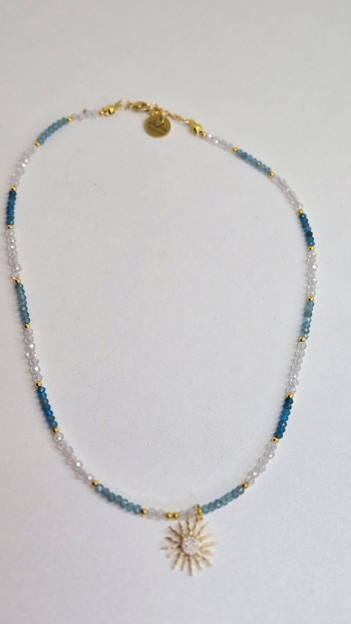 Sunlight Breeze Necklace with blue apatite stones and a cubic zirconia sun pendant, view 2