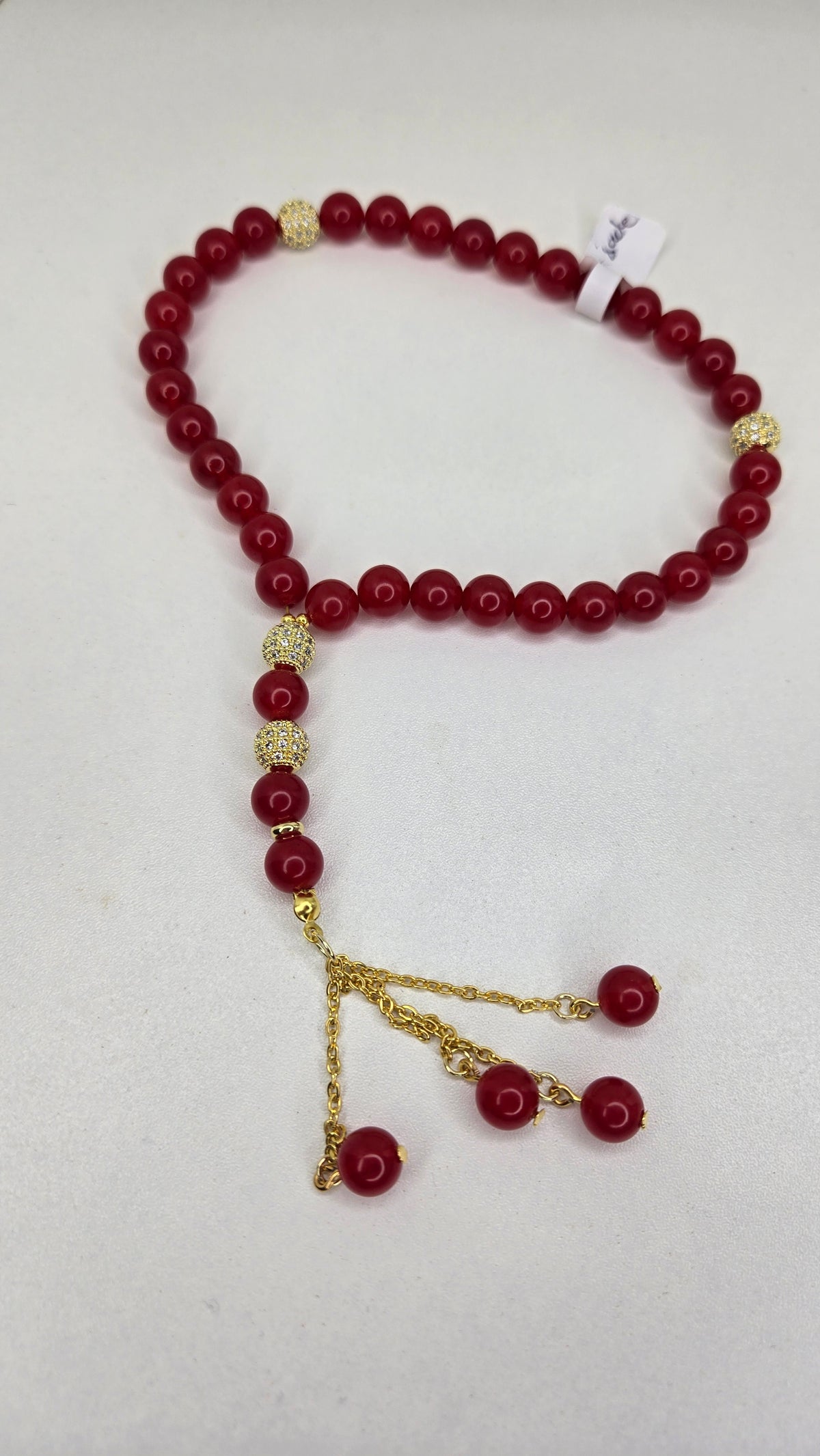 Red Jade Elegance Tasbih with red jade stones and gold-tone zircon-studded accents, view 2