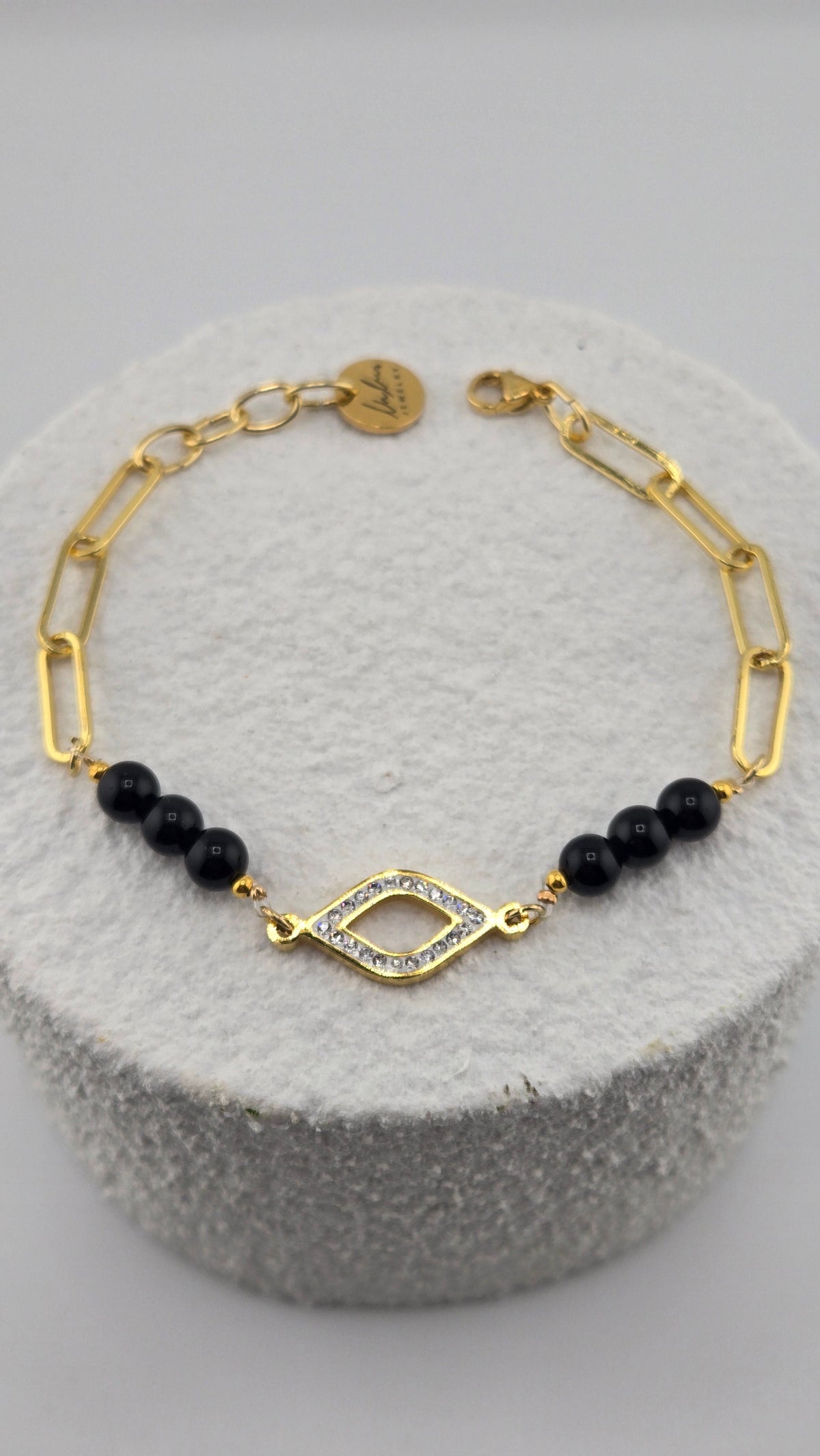 Obsidian Guardian Bracelet with black obsidian beads, evil eye centerpiece and gold-plated details