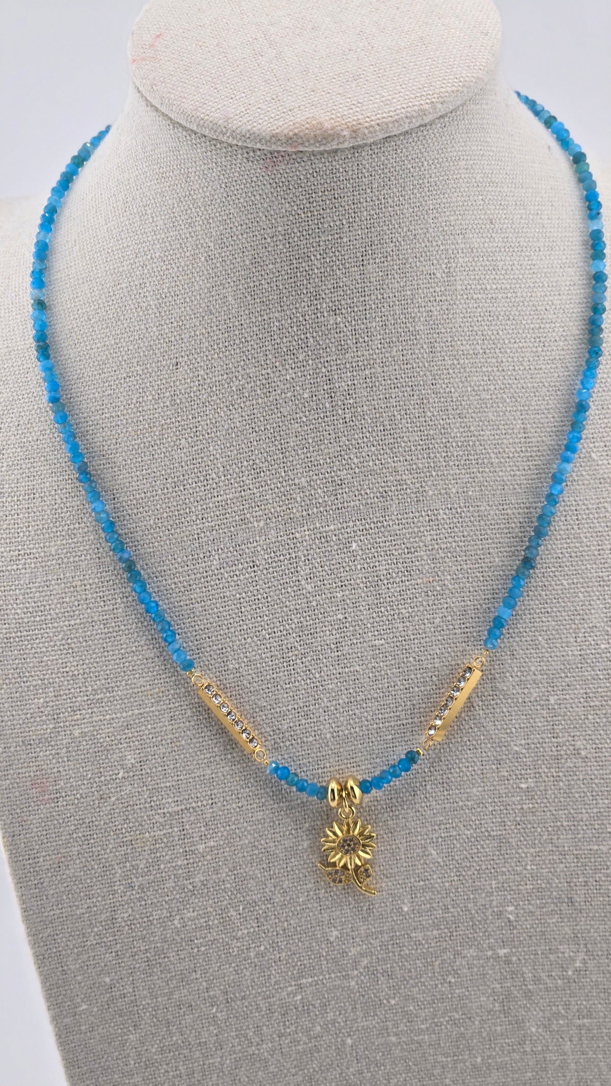 Ocean Bloom Apatite Necklace with blue apatite gemstones and a sunflower charm