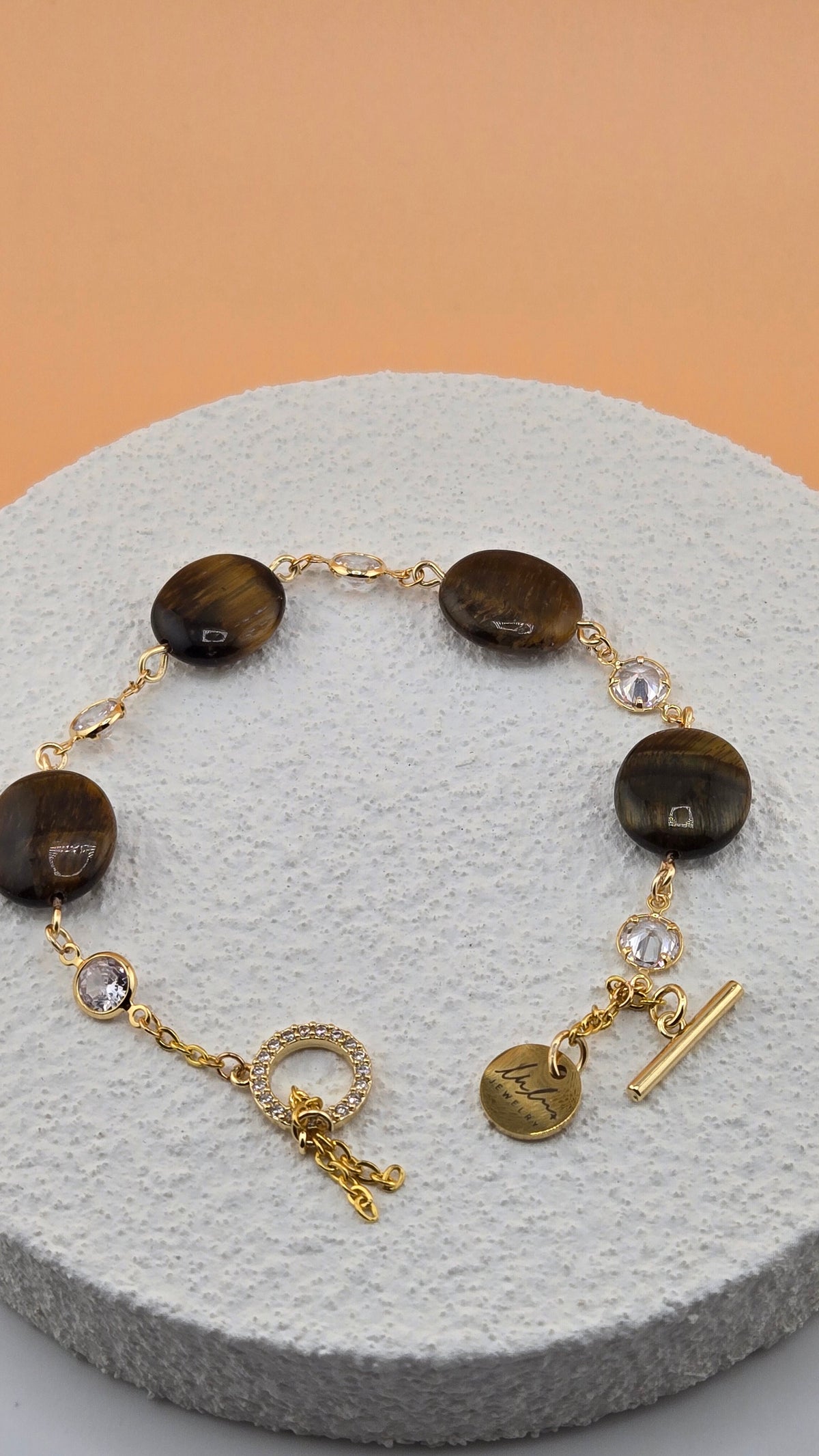 Tiger Eye Luxe Bracelet with brown tiger eye beads and dangling gold-tone charms