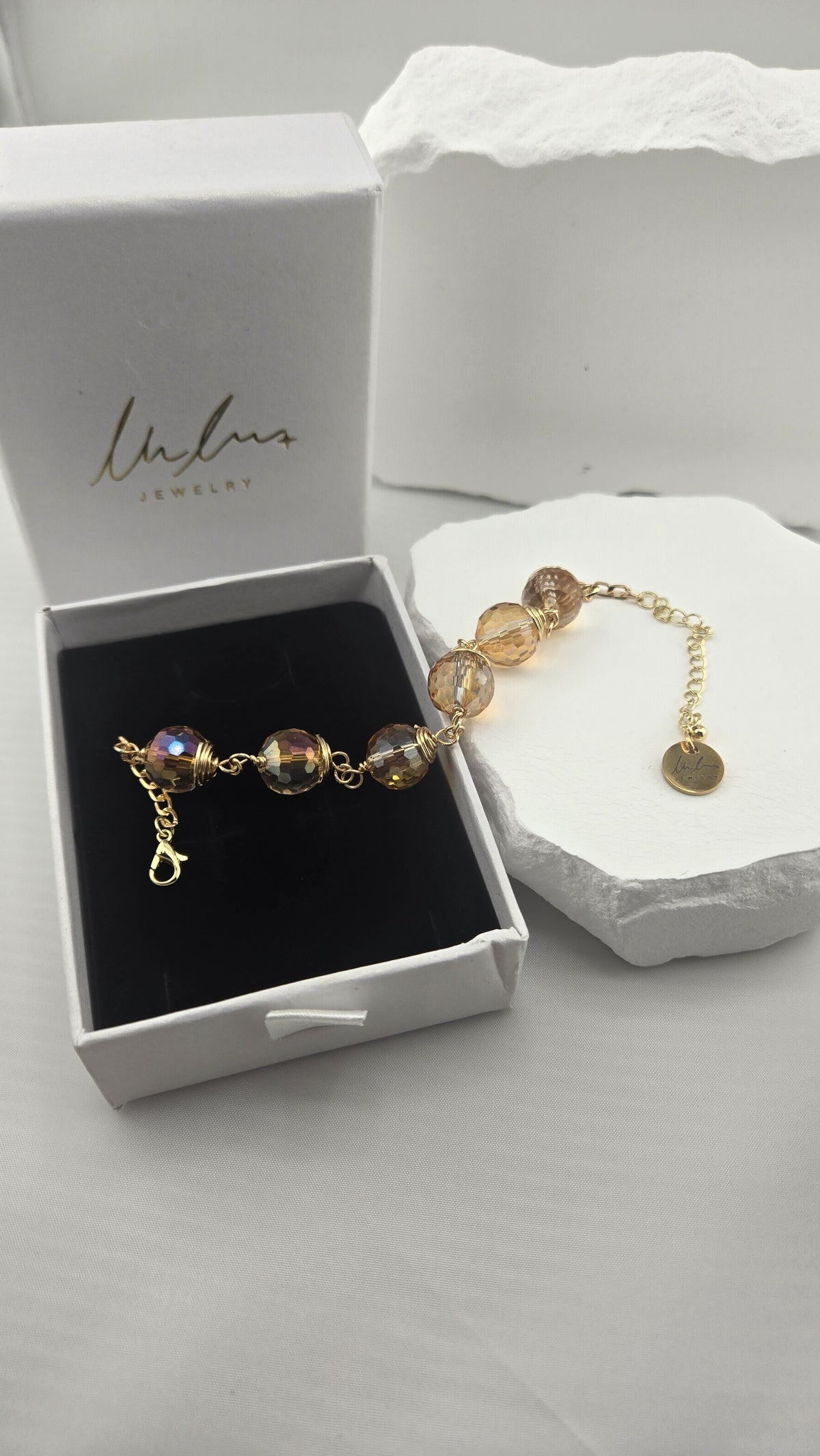 Firefly Orb Bracelet in an open gift box showing the shimmer of the beads