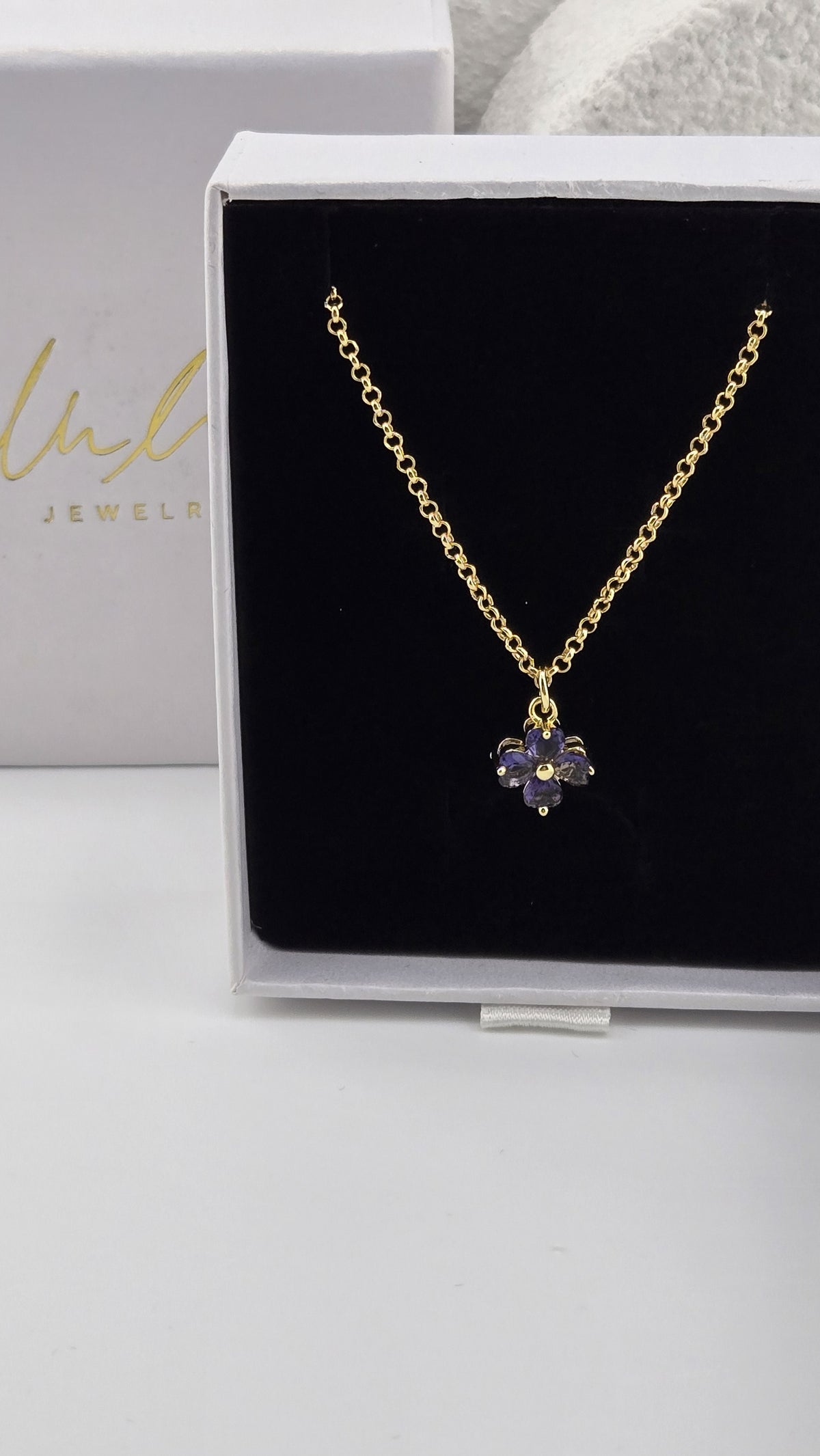 Meadow Clover Necklace in purple, four-leaf clover pendant with heart-shaped purple stones on a gold-plated chain in a LuluTouch gift box