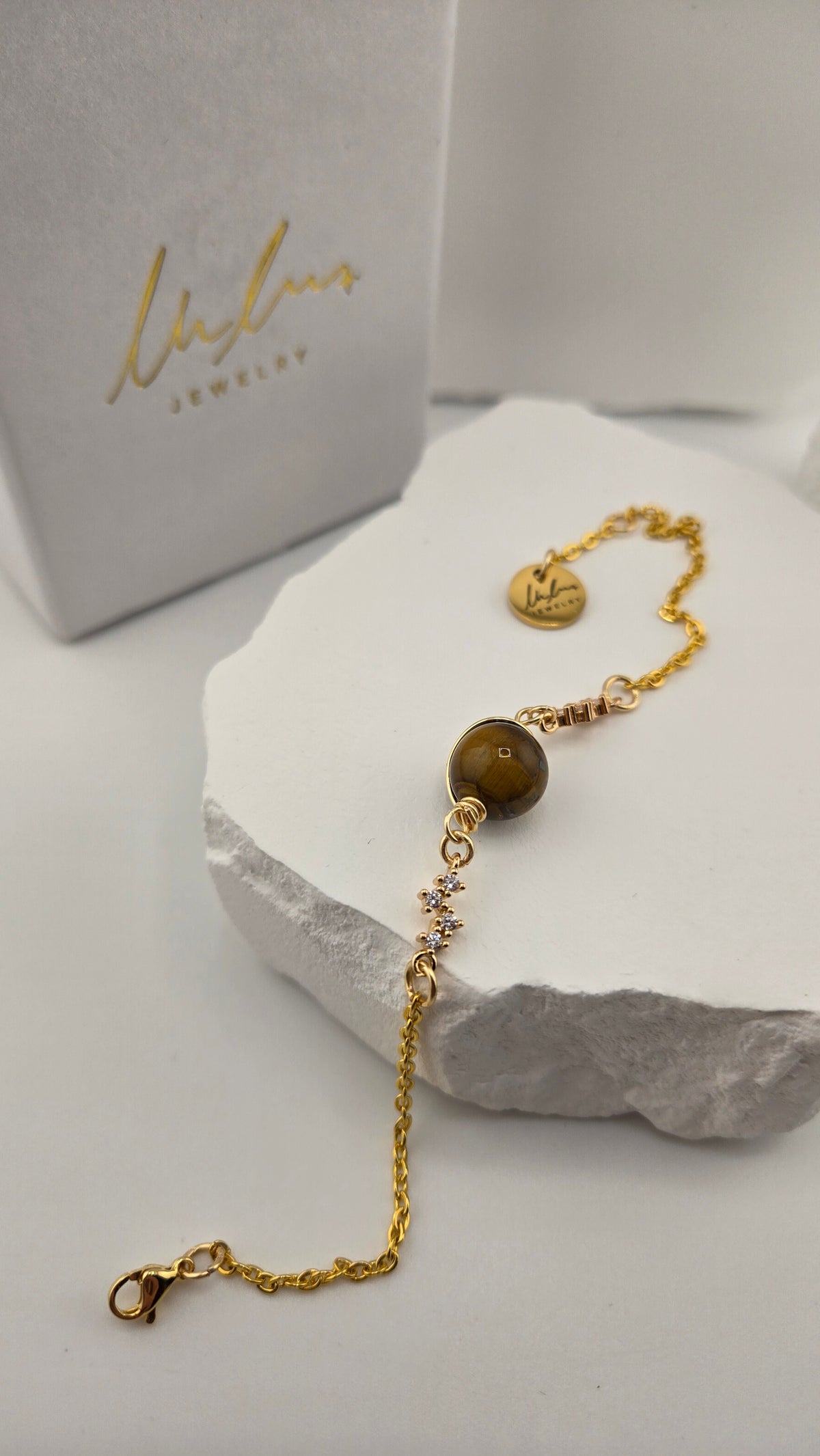 Saturn Tiger's Eye Bracelet showing lobster clasp and logo charm, view 3