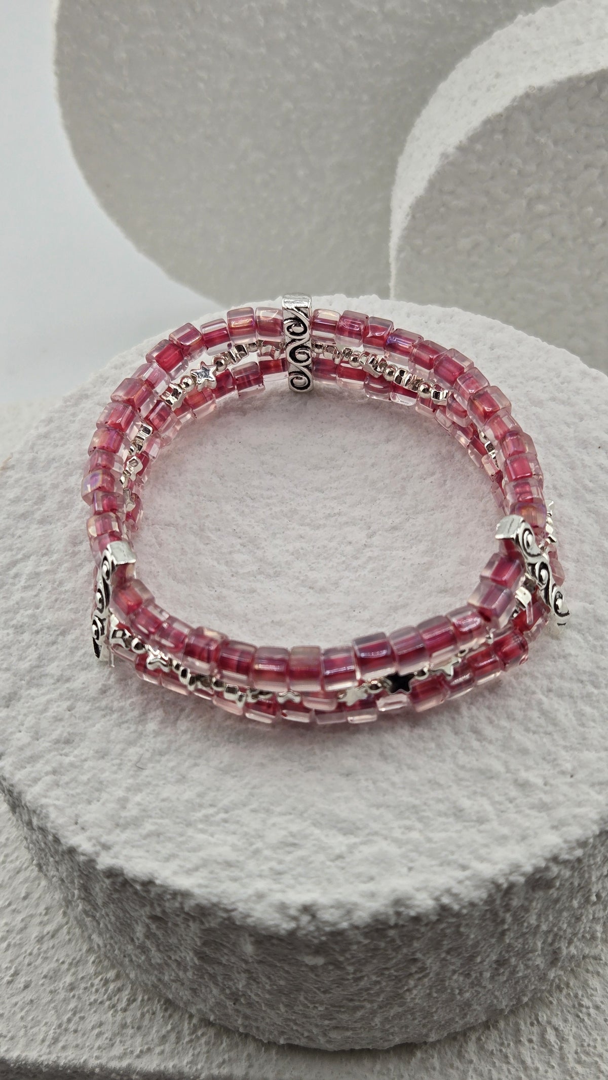 Starlit Raspberry Bracelet on a white stone stand, view 2