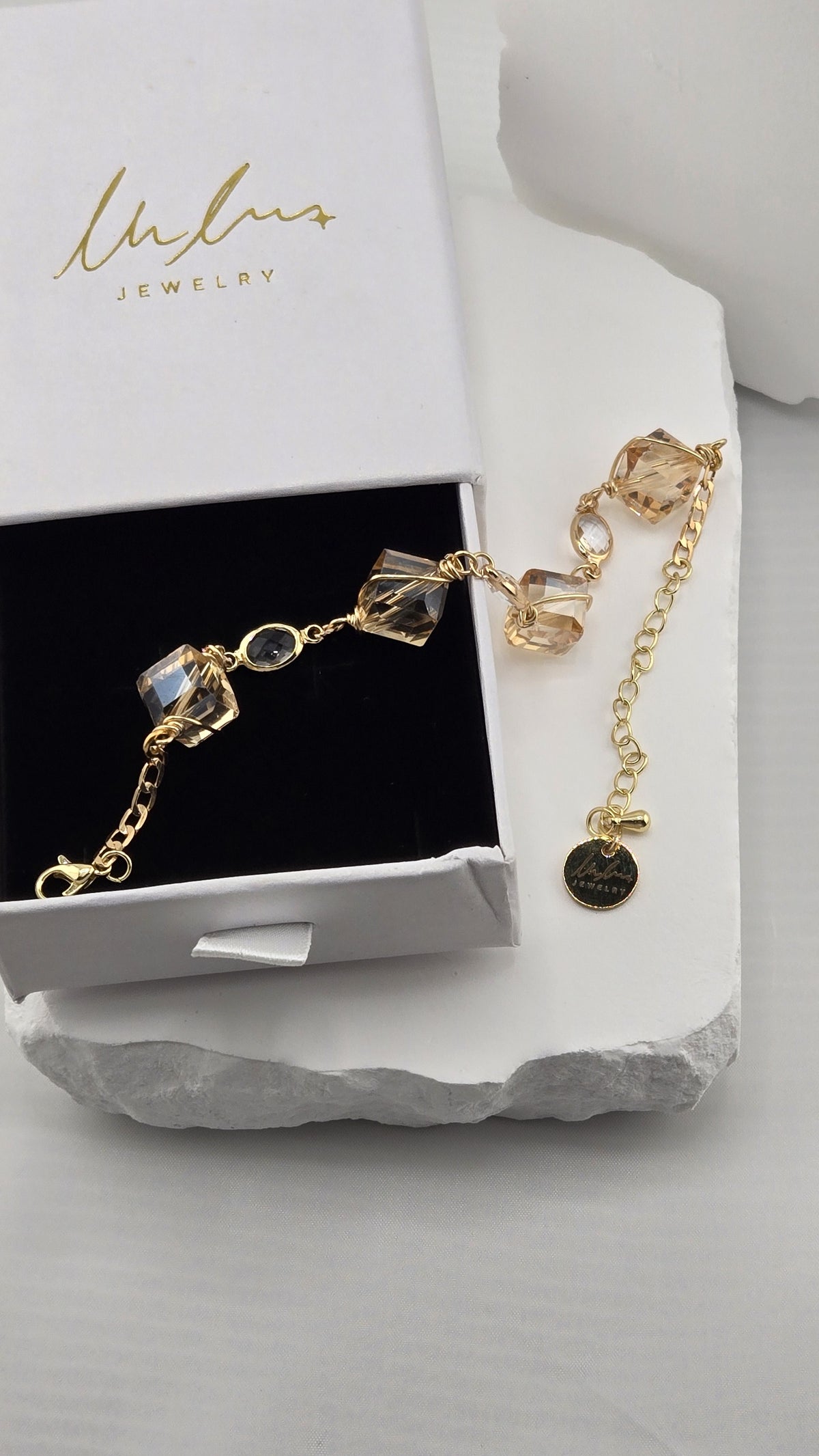 Sunlit Cube Bracelet draped from a LuluTouch gift box