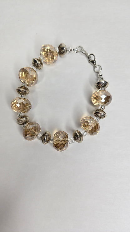 Elegance bracelet with faceted champagne-colored beads and patterned silver-tone spacers