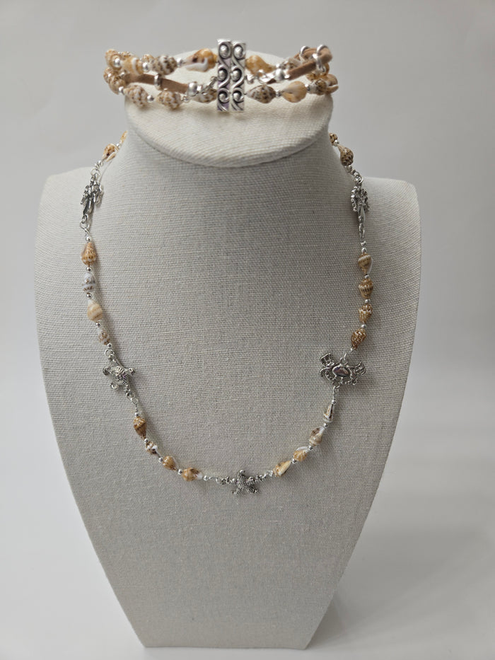Seashell Necklace with beige seashells and floral and turtle-shaped metal charms