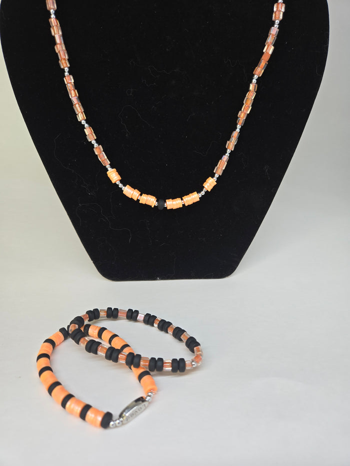 Orange Pulse Beaded Jewelry necklace and two bracelets in orange and black beads