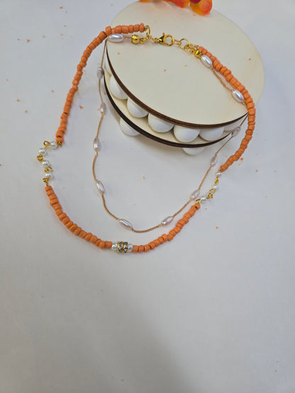 Sunset Pearl Orange Beaded Necklace with orange chip beads and white accents