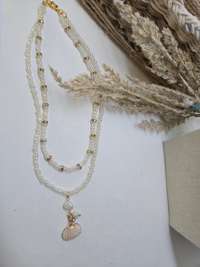 Sea Pearl Necklace with two layers of white beads, gold-tone accents and a shell charm