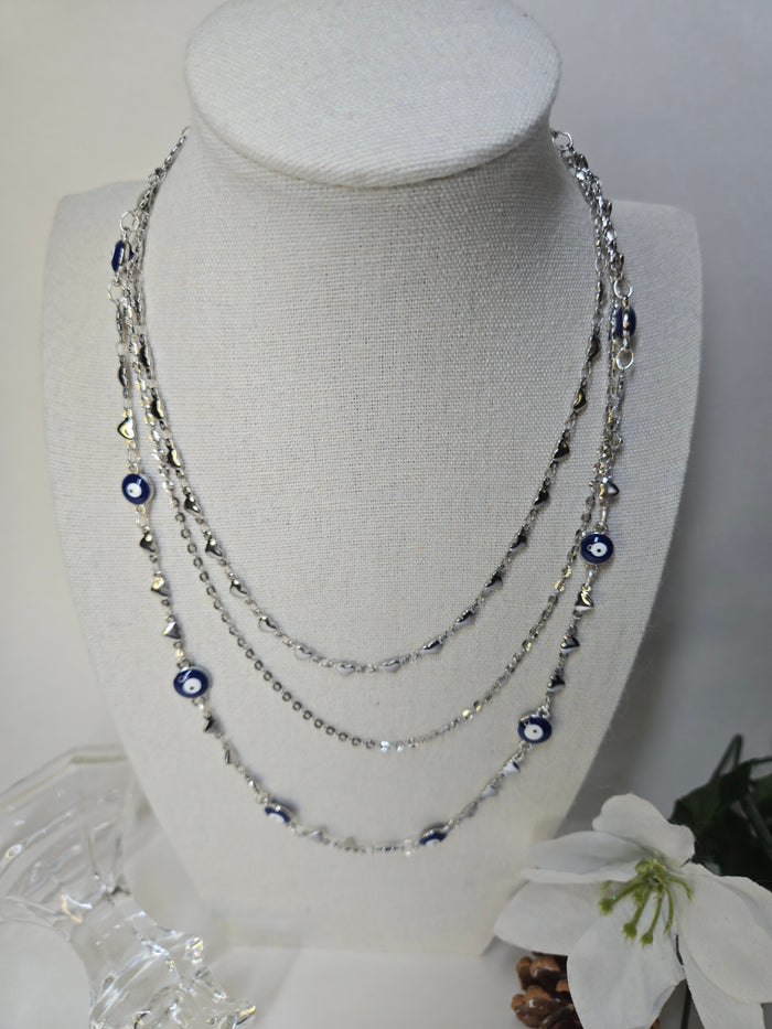 Evil Eye Embrace Layered Necklace with silver-tone chains and blue evil-eye motifs