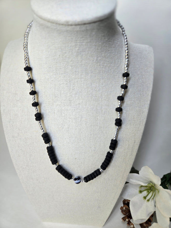 Shadow Tone Necklace with black polymer rings, silver beads and a striped center bead