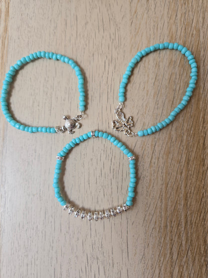 Ocean Charms Turquoise-Tone Bracelets, three handmade designs with turquoise-colored beads: a silver-tone turtle charm, a silver-tone openwork winged charm, and sparkly silver-tone spacers