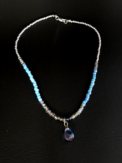 Blue Teardrop Necklace with clear-to-blue glass beads and a blue-violet teardrop pendant