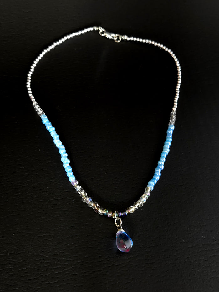 Blue Teardrop Necklace with clear-to-blue glass beads and a blue-violet teardrop pendant