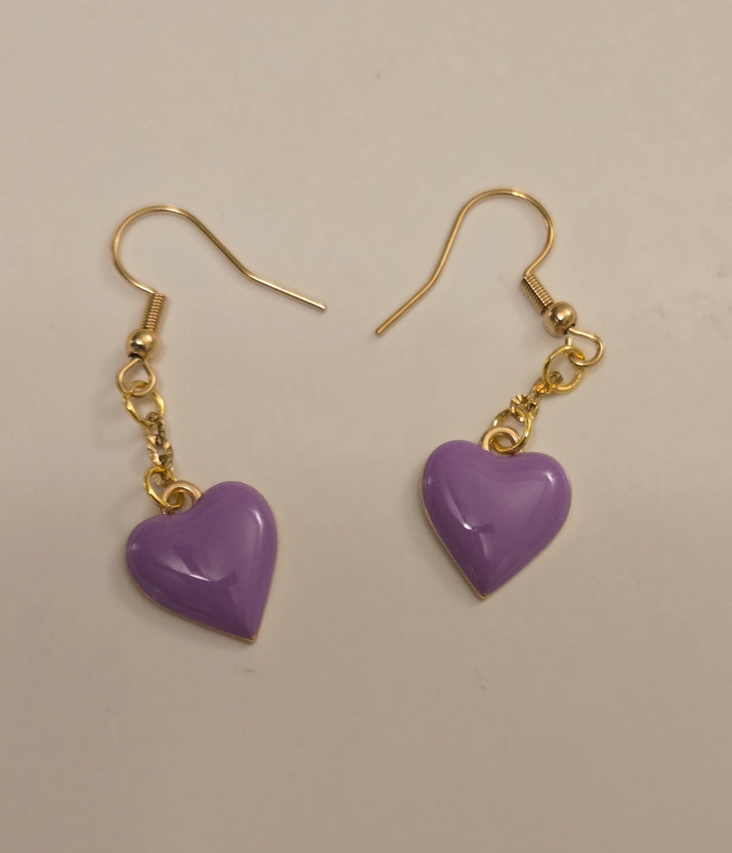 Lavender Heart Earrings displayed in elegant lighting