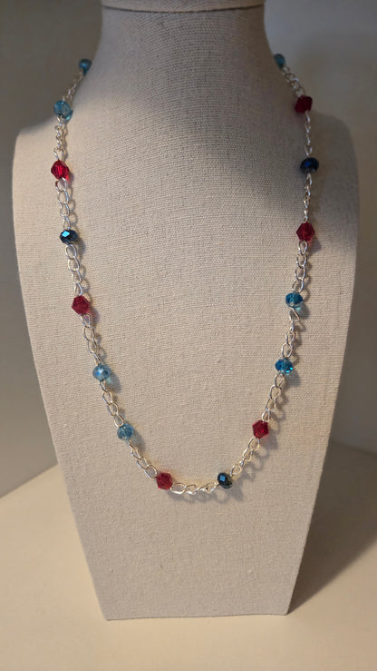 Dual Elegance Necklace with deep blue and red beads on a silver chain