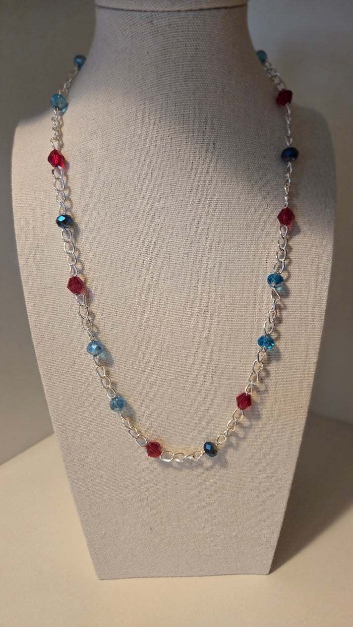 Dual Elegance Necklace with deep blue and red beads on a silver chain