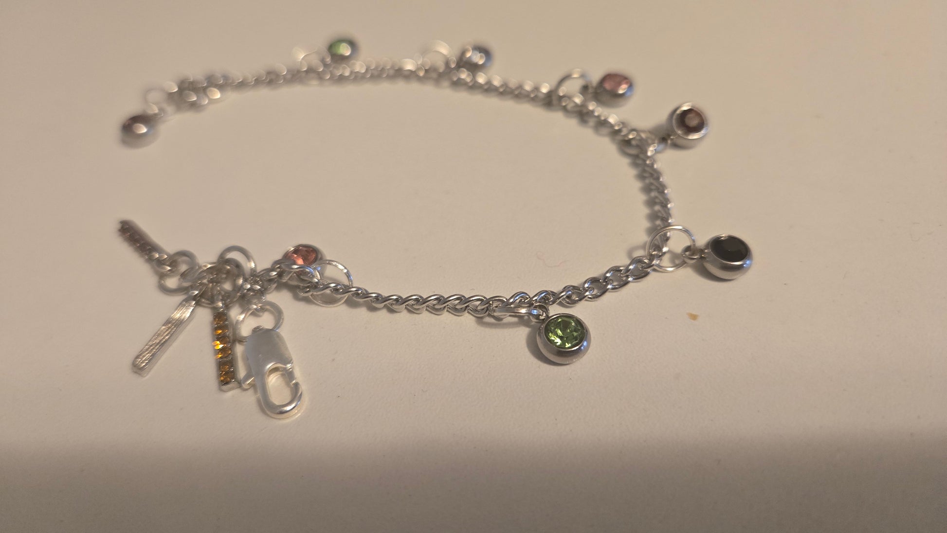 Close-up of Silver Charm Bracelet with vibrant colorful gemstone accents