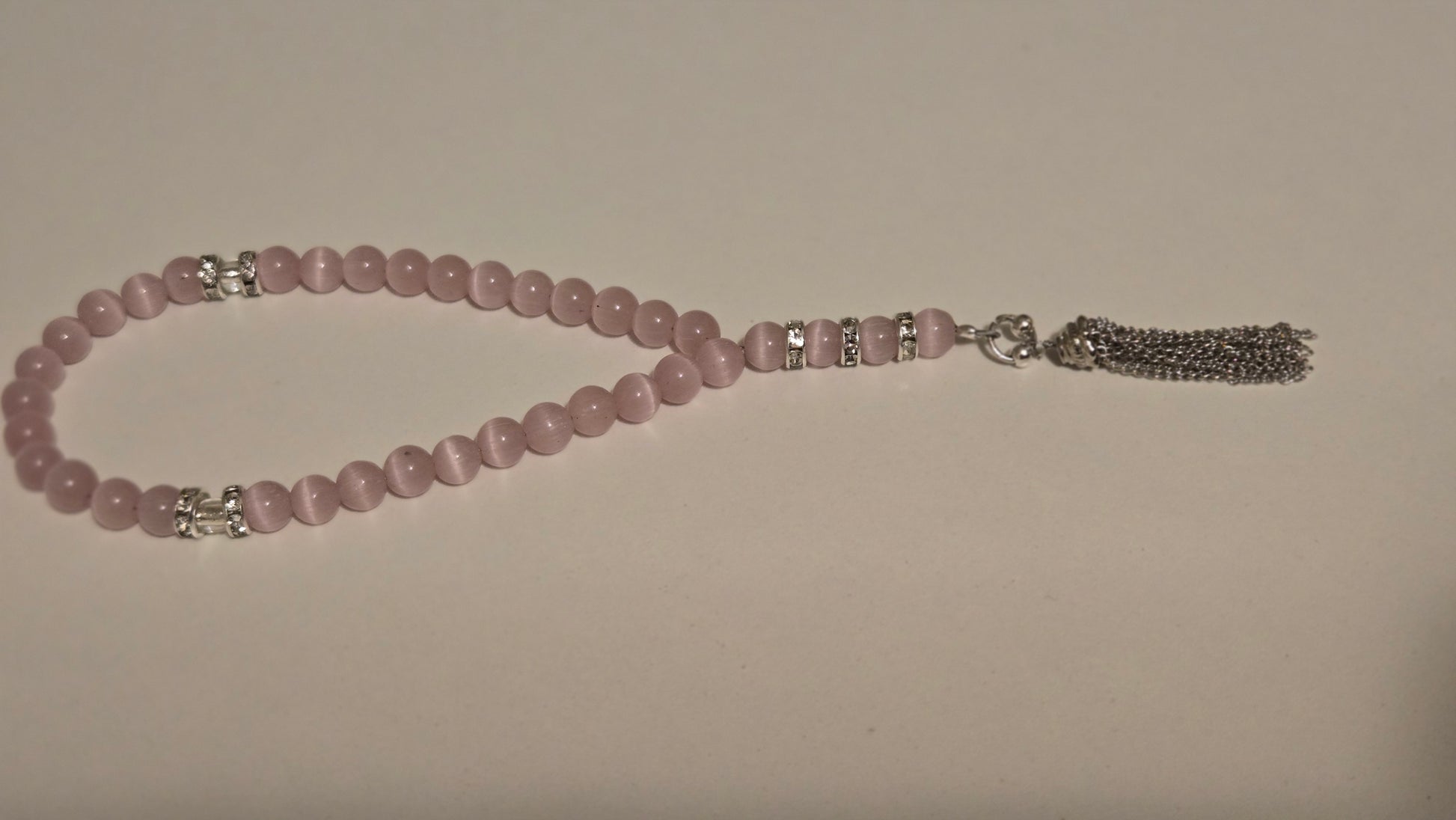 Blush Serenity Tasbih with soft pink beads and silver accents on a light background