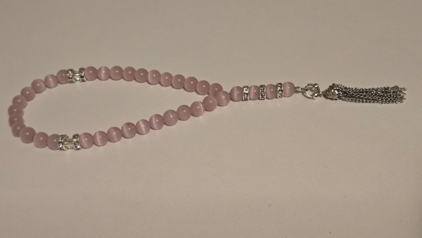 Close-up of the delicate blush pink beads and silver spacer beads of the handmade tasbih