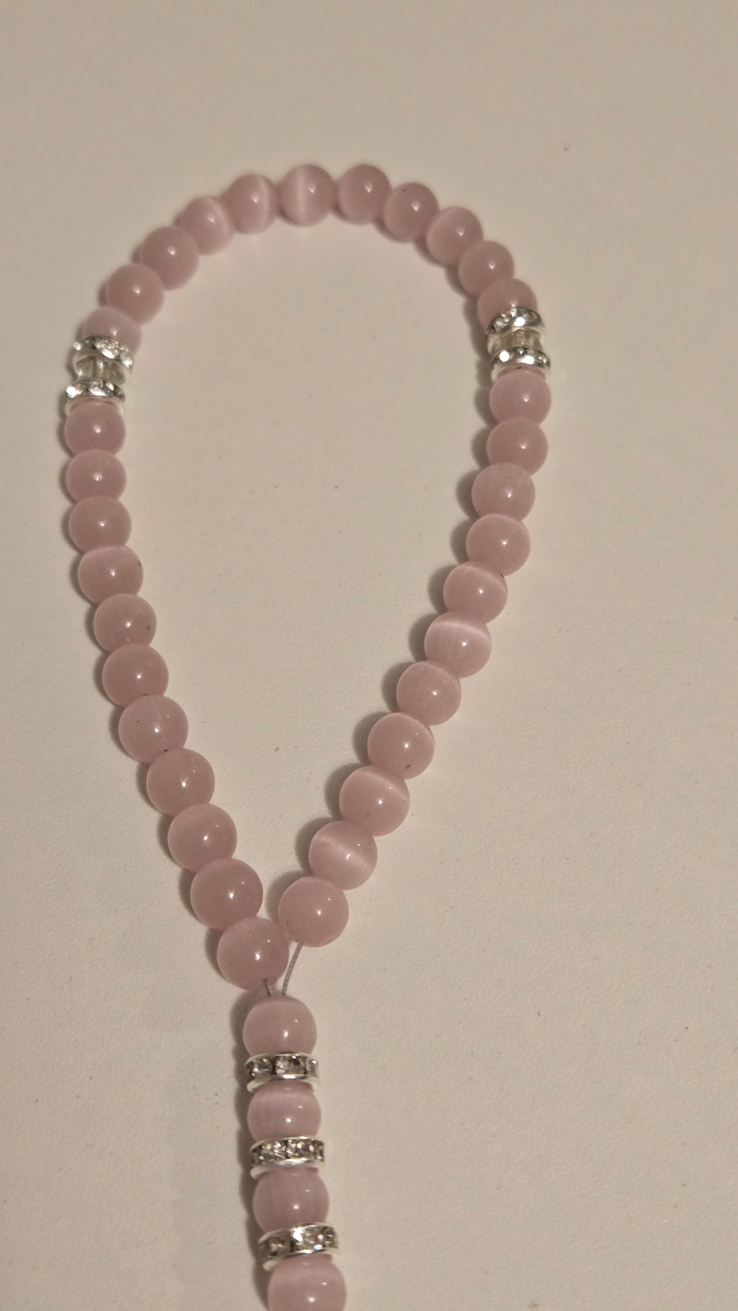 Blush Serenity Tasbih held gently in a woman's hand, emphasizing comfort and daily use