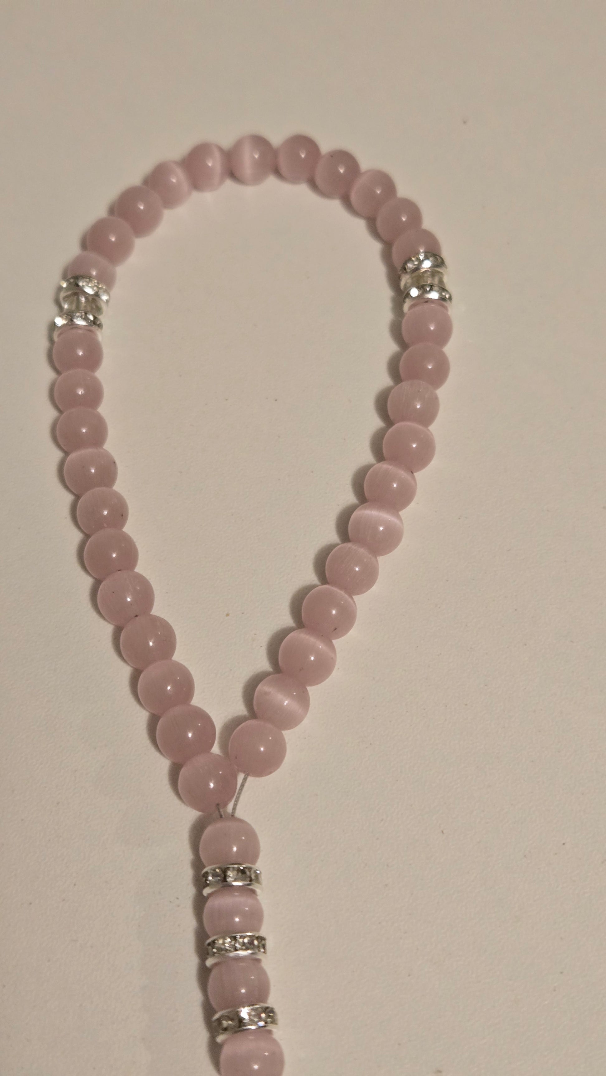 Blush Serenity Tasbih held gently in a woman's hand, emphasizing comfort and daily use